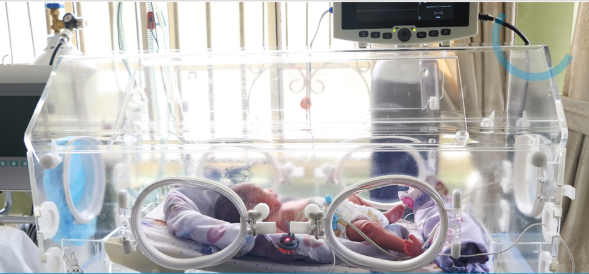 Newborn in a special care baby unit incubator